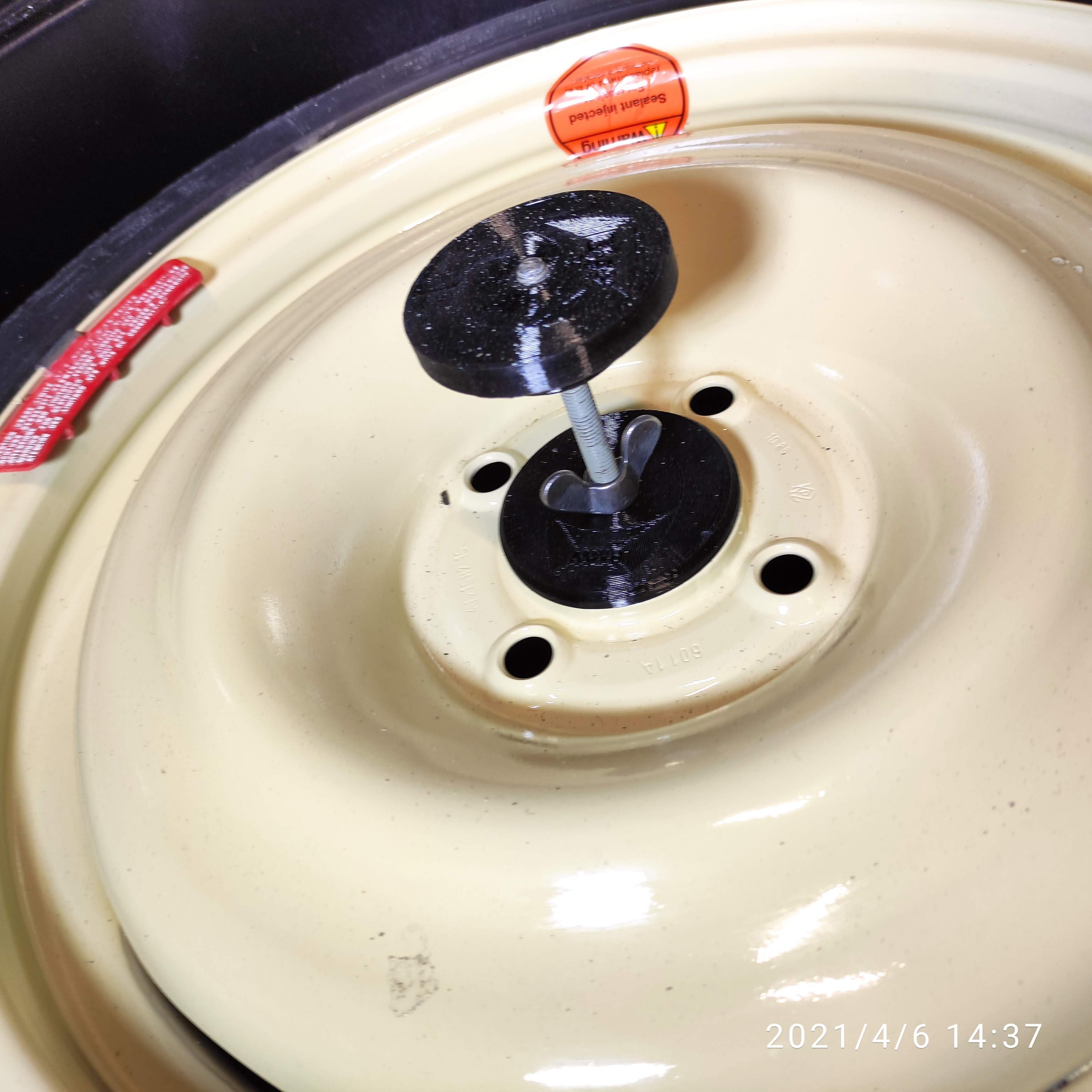 Spare-Wheel Retaining Cover and Holder — image 1 of 1